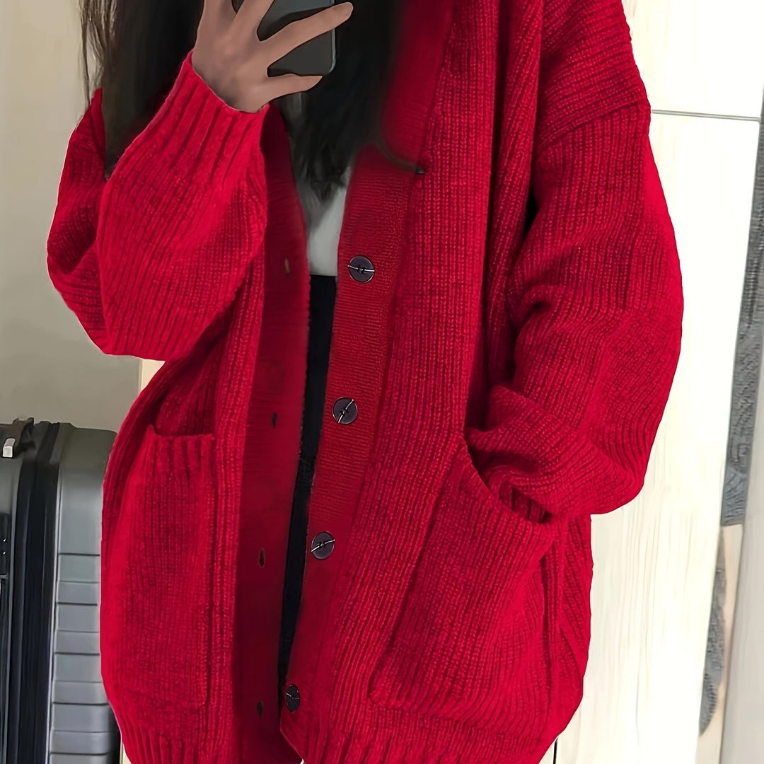Red ribbed knit cardigan close-up highlighting chunky button detail