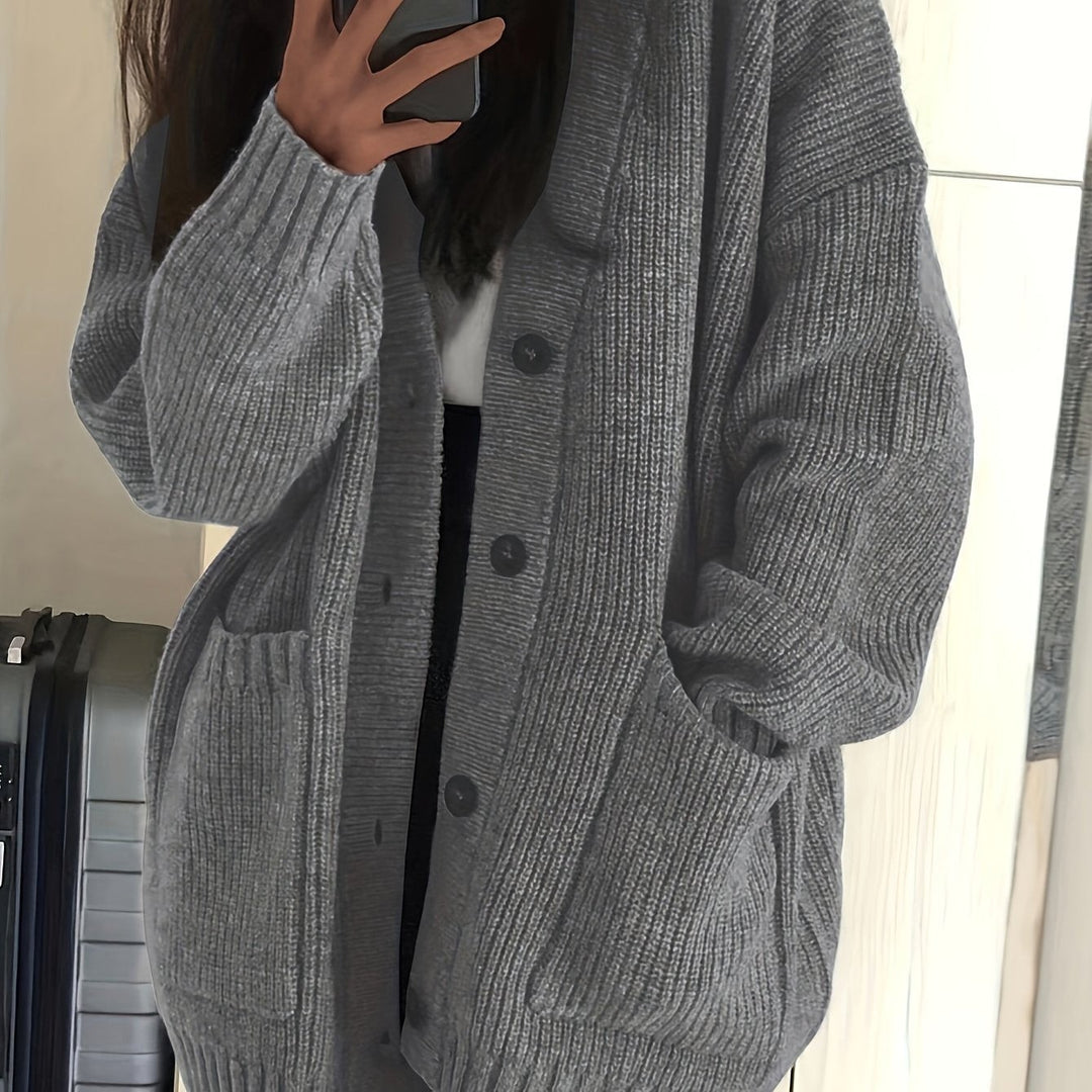 Grey ribbed knit cardigan close-up showing textured knit and pockets