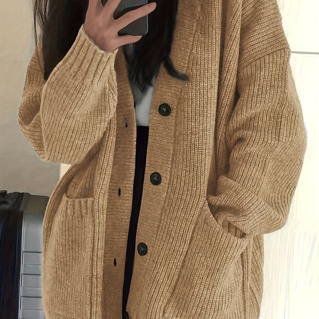 Camel ribbed knit cardigan close-up showing sleeve and pocket detail