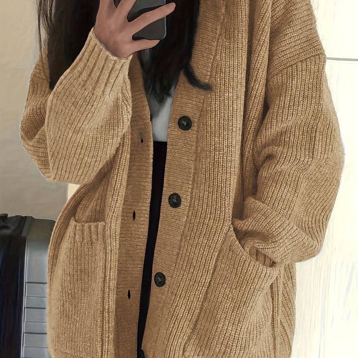 Camel ribbed knit cardigan close-up showing sleeve and pocket detail
