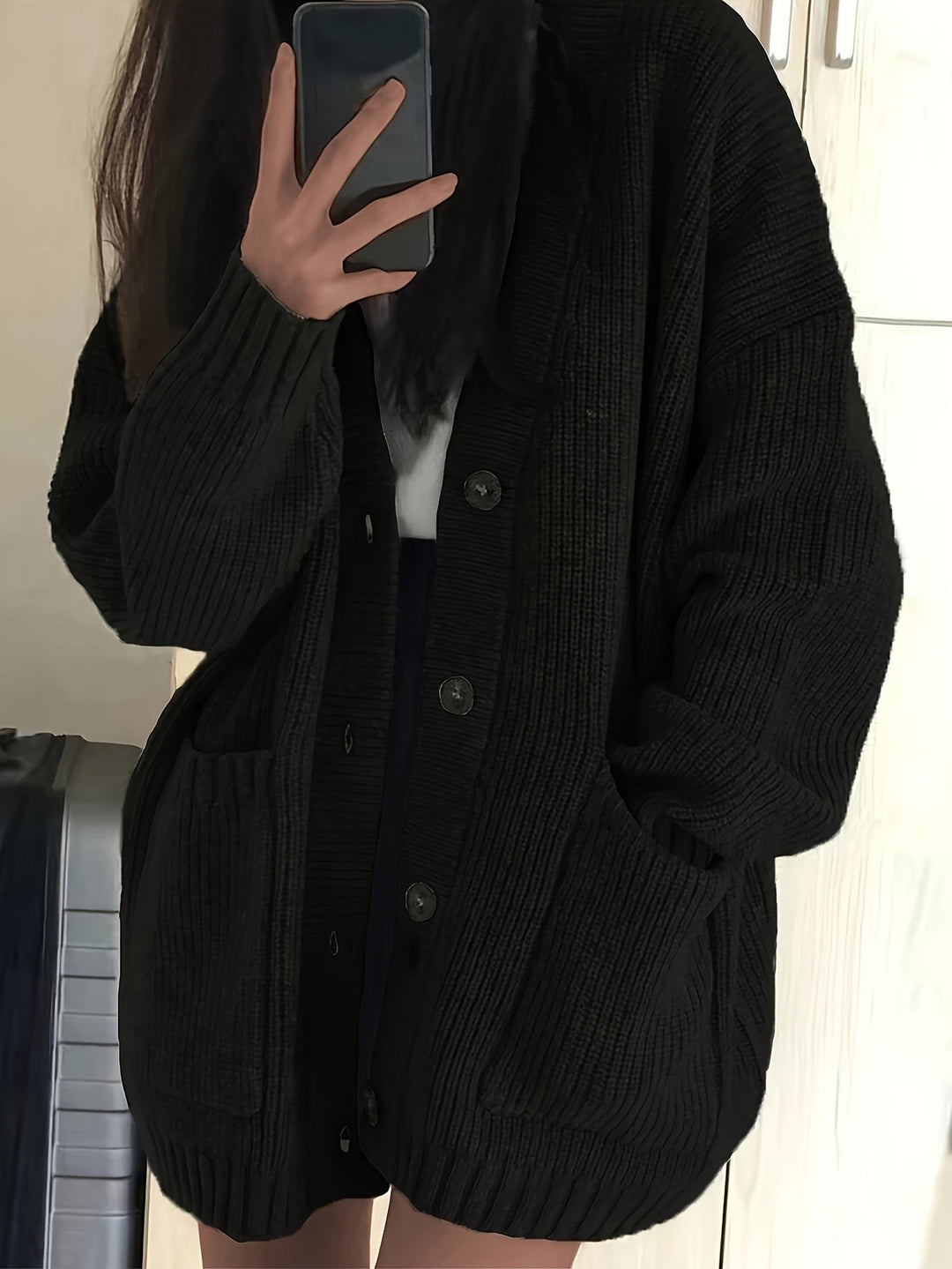 Black ribbed knit button-front cardigan with slouchy oversized fit