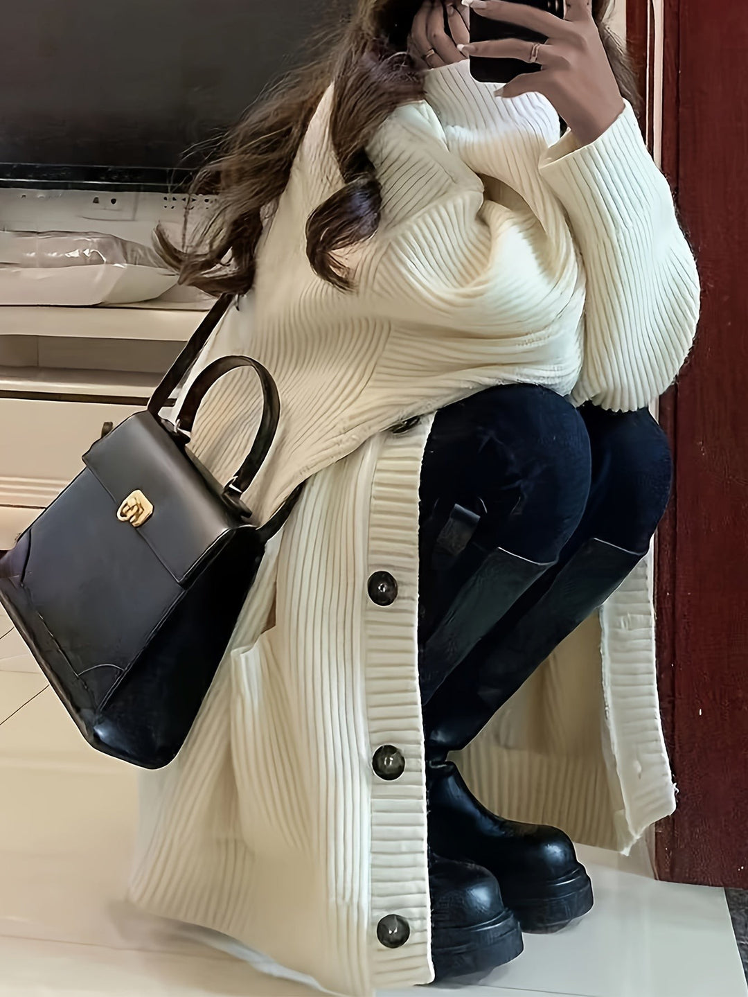 Cream ribbed knit longline cardigan paired with knee-high boots