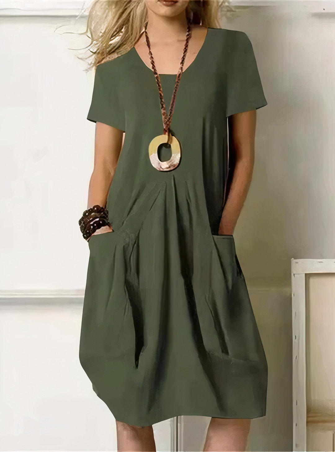 olive green short-sleeve shift dress with front pockets and V-neck