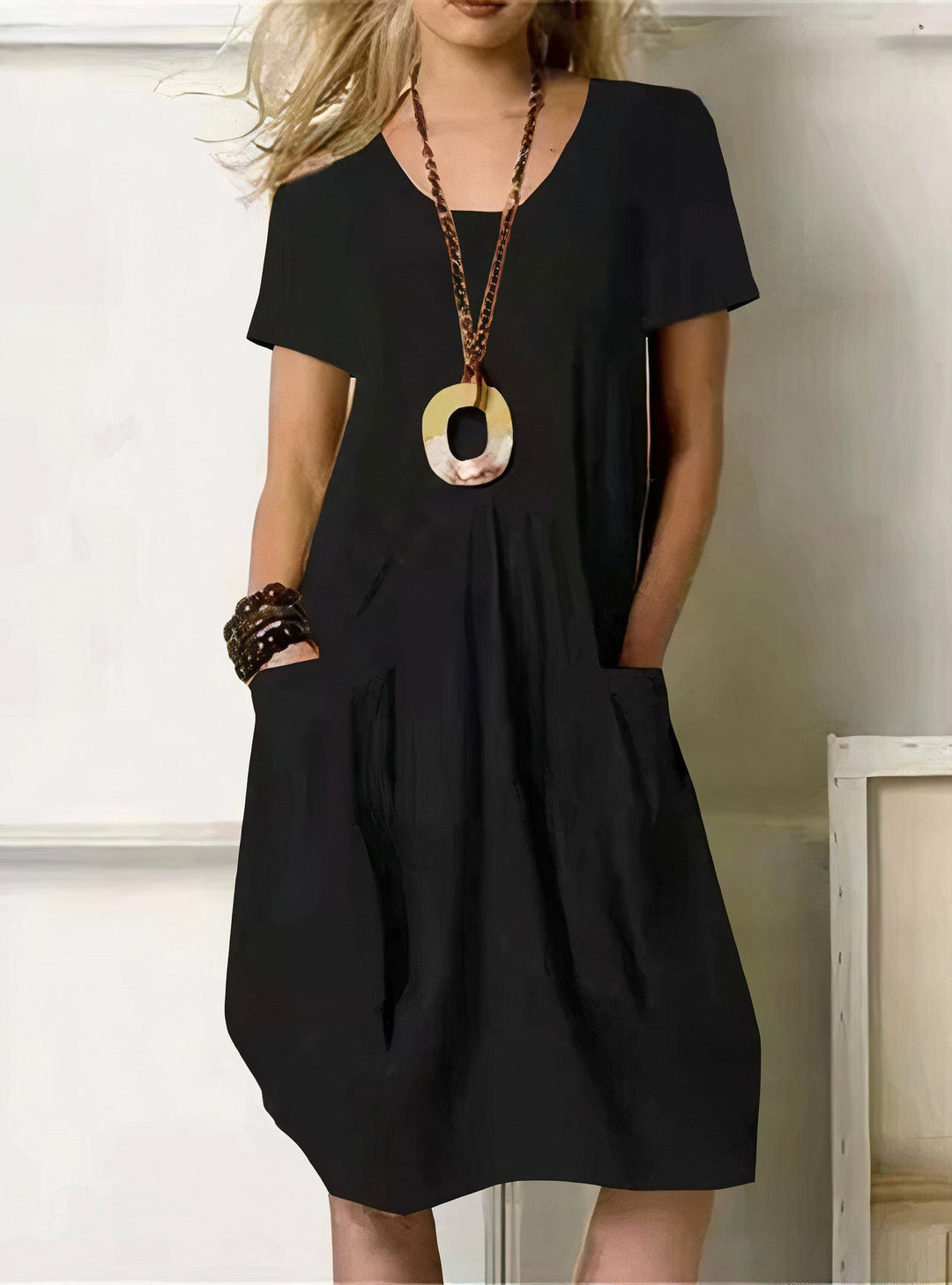 black short-sleeve shift dress with front pockets and V-neck