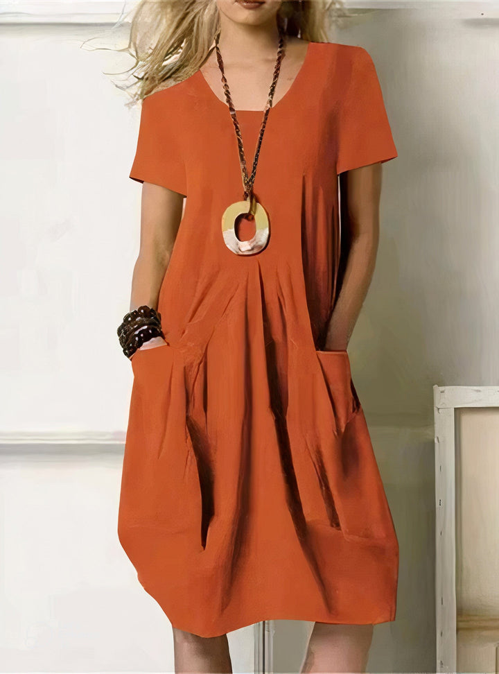 burnt orange short-sleeve shift dress with front pockets and V-neck
