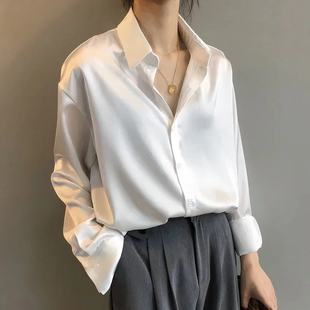 White satin button-down blouse with relaxed long sleeves and collar