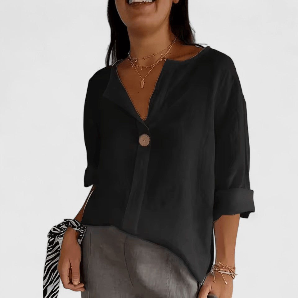 Black split-neck blouse with single button and rolled three-quarter sleeves