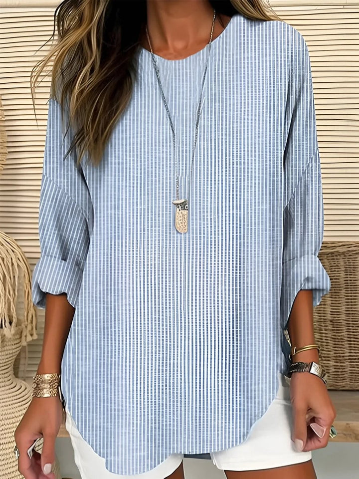 Blue and white striped crew-neck blouse with long sleeves and curved hem