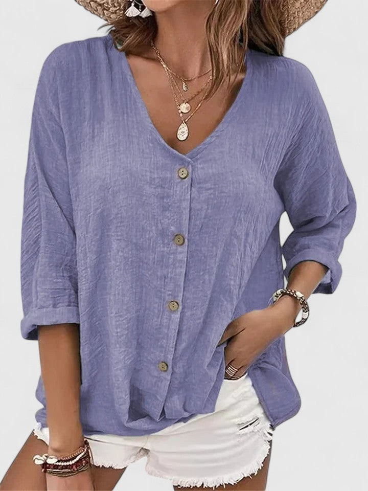 Periwinkle button-down linen top with relaxed V-neck and rolled sleeves