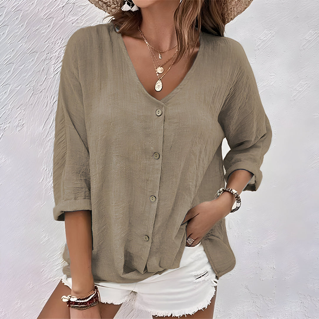 Olive green textured button-up blouse with V-neck paired with denim shorts