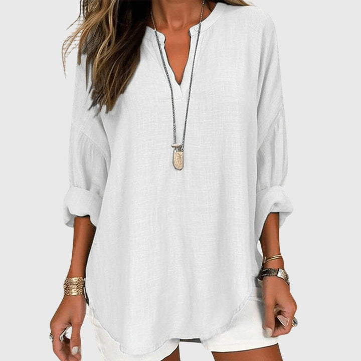 White flowy V-neck blouse with rolled long sleeves, layered necklace