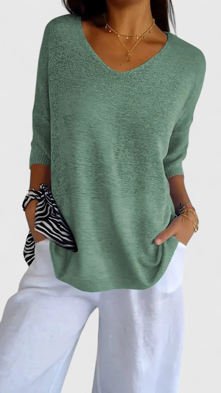 Sage green V-neck knit top with three-quarter sleeves and relaxed fit