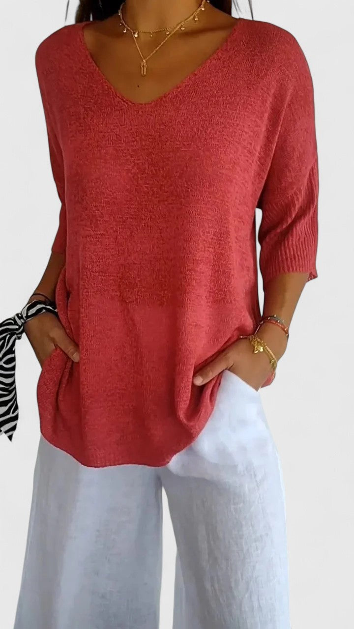 Coral V-neck knit top with three-quarter sleeves, oversized silhouette