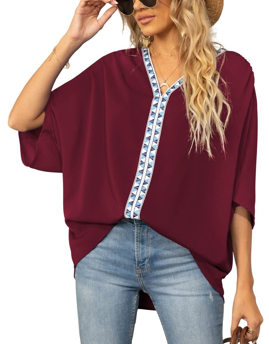 Burgundy relaxed-fit blouse featuring geometric V-neck trim and half sleeves