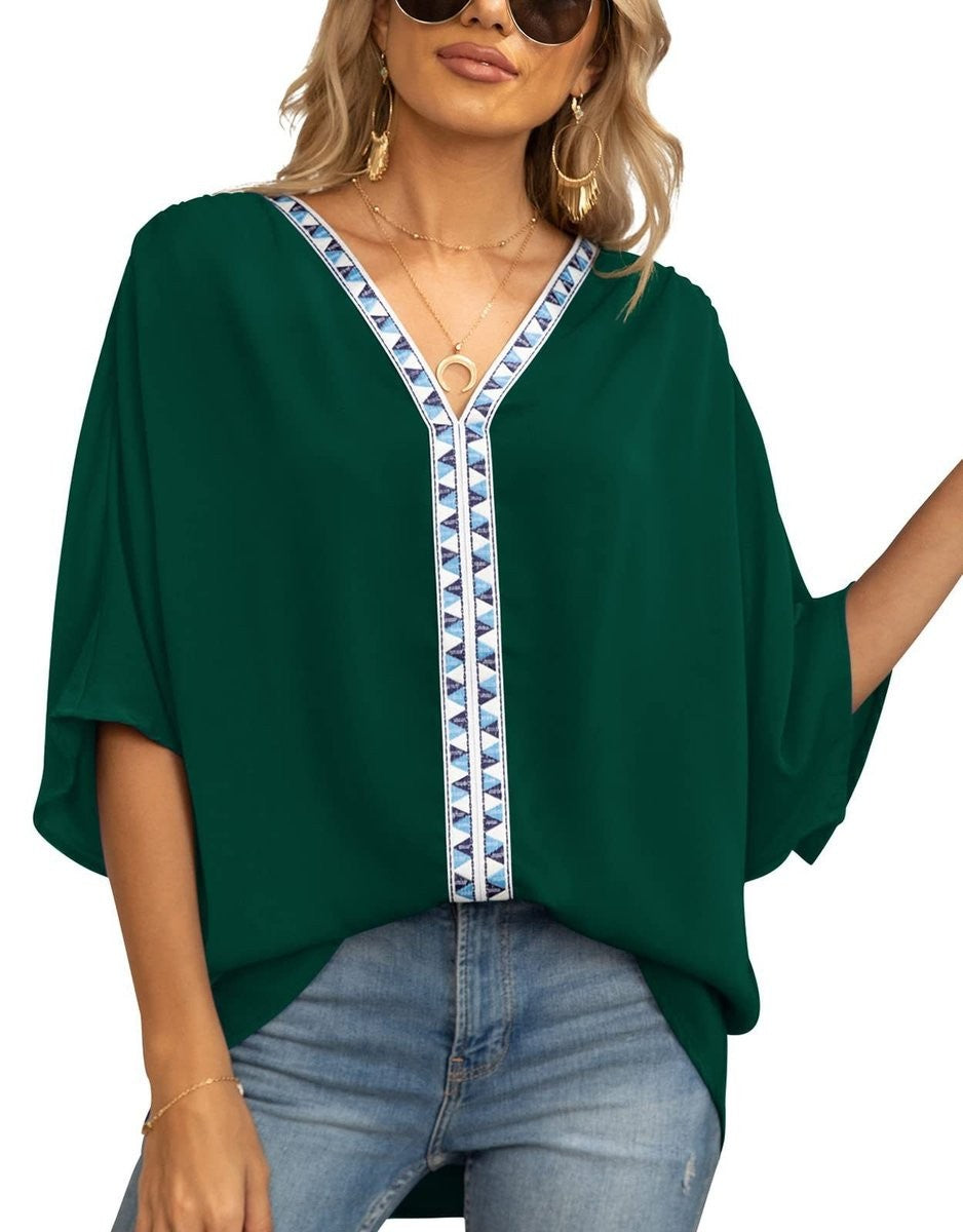 Emerald green oversized tunic top with embroidered V-neck trim and batwing sleeves