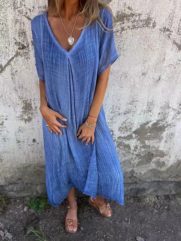 Blue V-neck maxi dress featuring short sleeves and relaxed flowy silhouette
