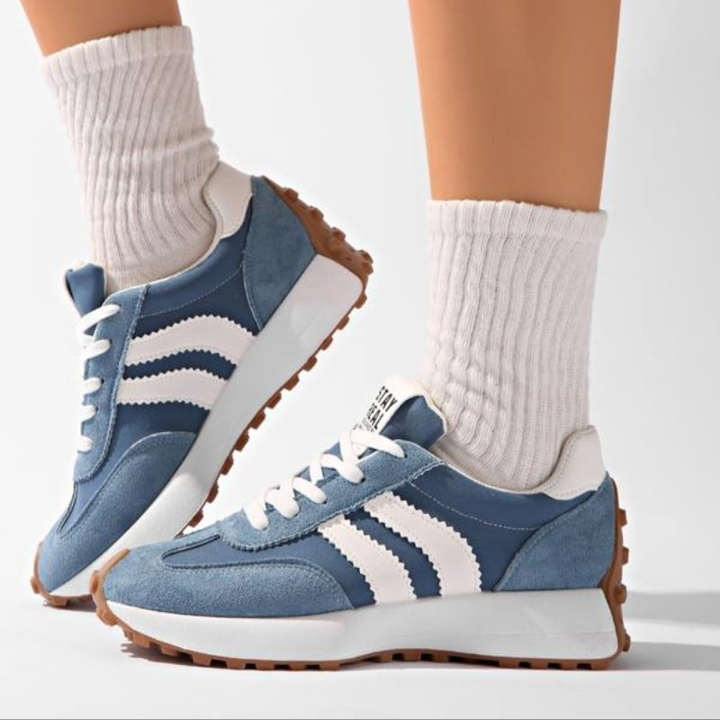 Blue suede retro sneakers with white stripes paired with ribbed socks