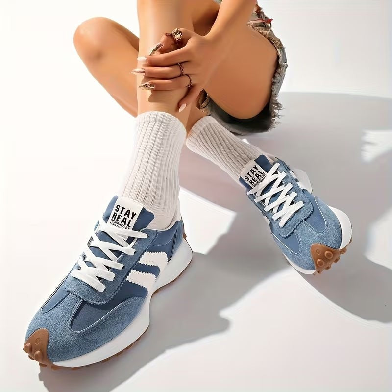 Blue platform sneakers with white accents worn with white ribbed socks