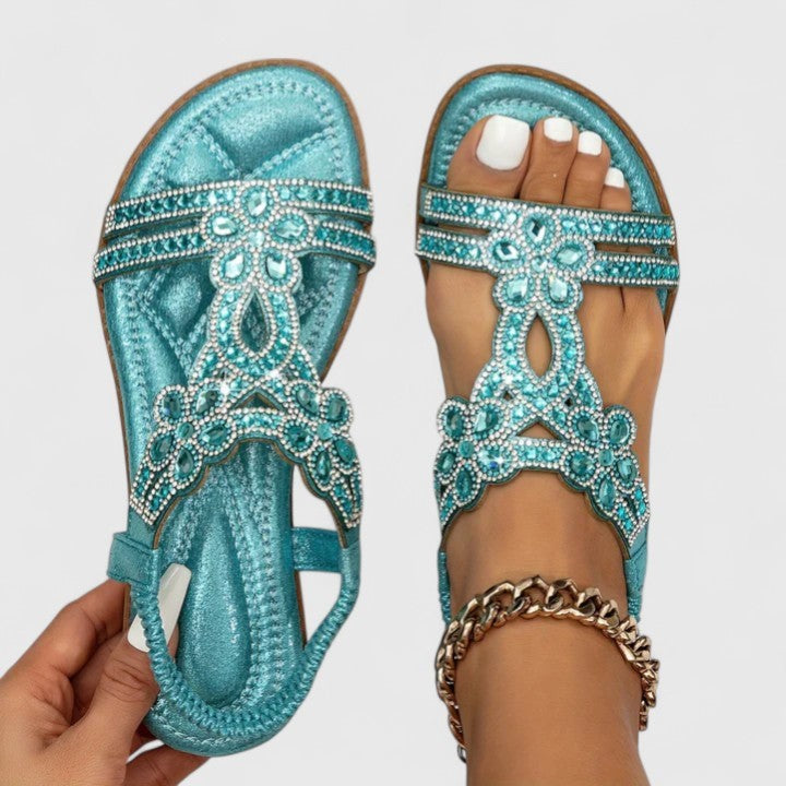 teal jeweled flat sandal with metallic finish and floral cutouts