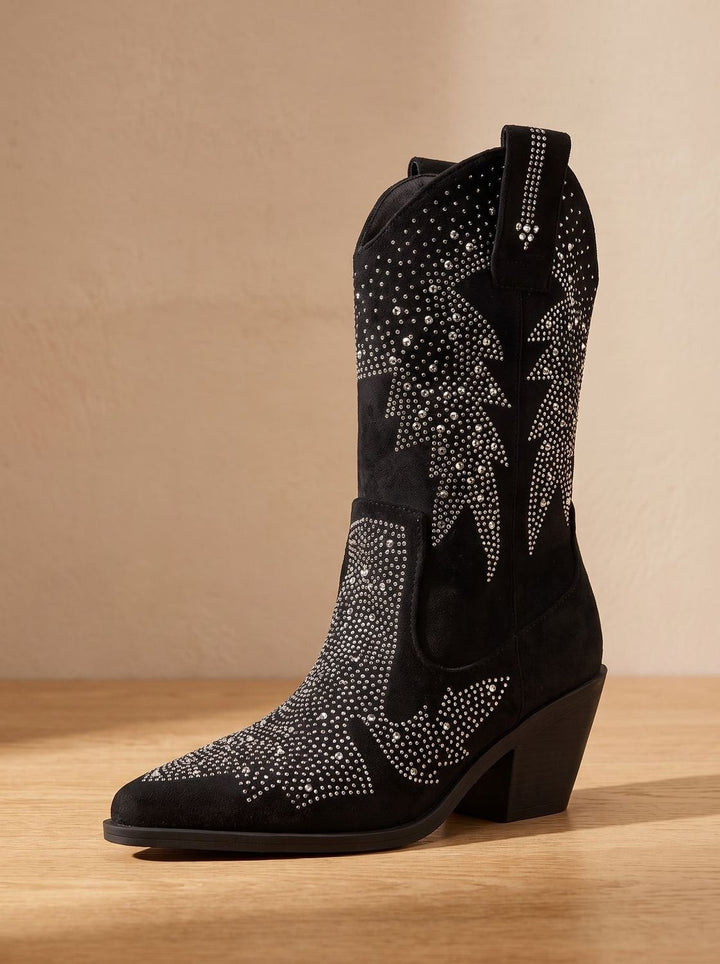 Side view of black cowboy boot showing rhinestone starburst pattern and pointed toe