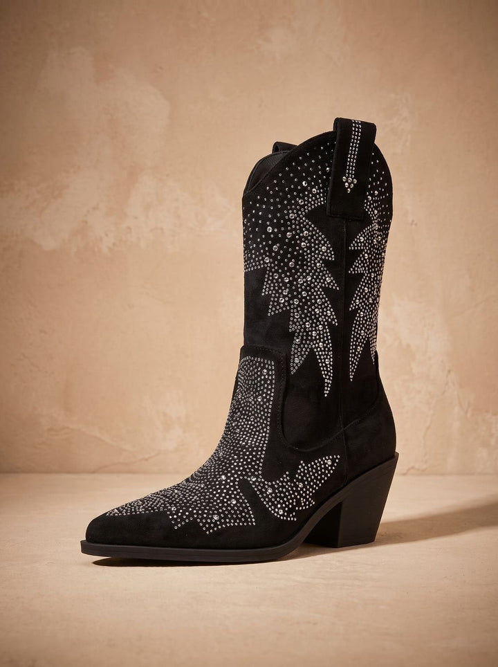 Single black western boot displaying rhinestone detailing against textured beige backdrop