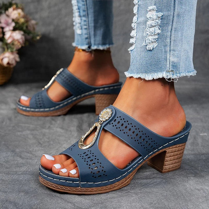 blue perforated wedge sandals with metallic rhinestone accent