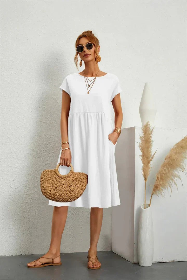 White short-sleeve casual dress with pockets and flowy midi length