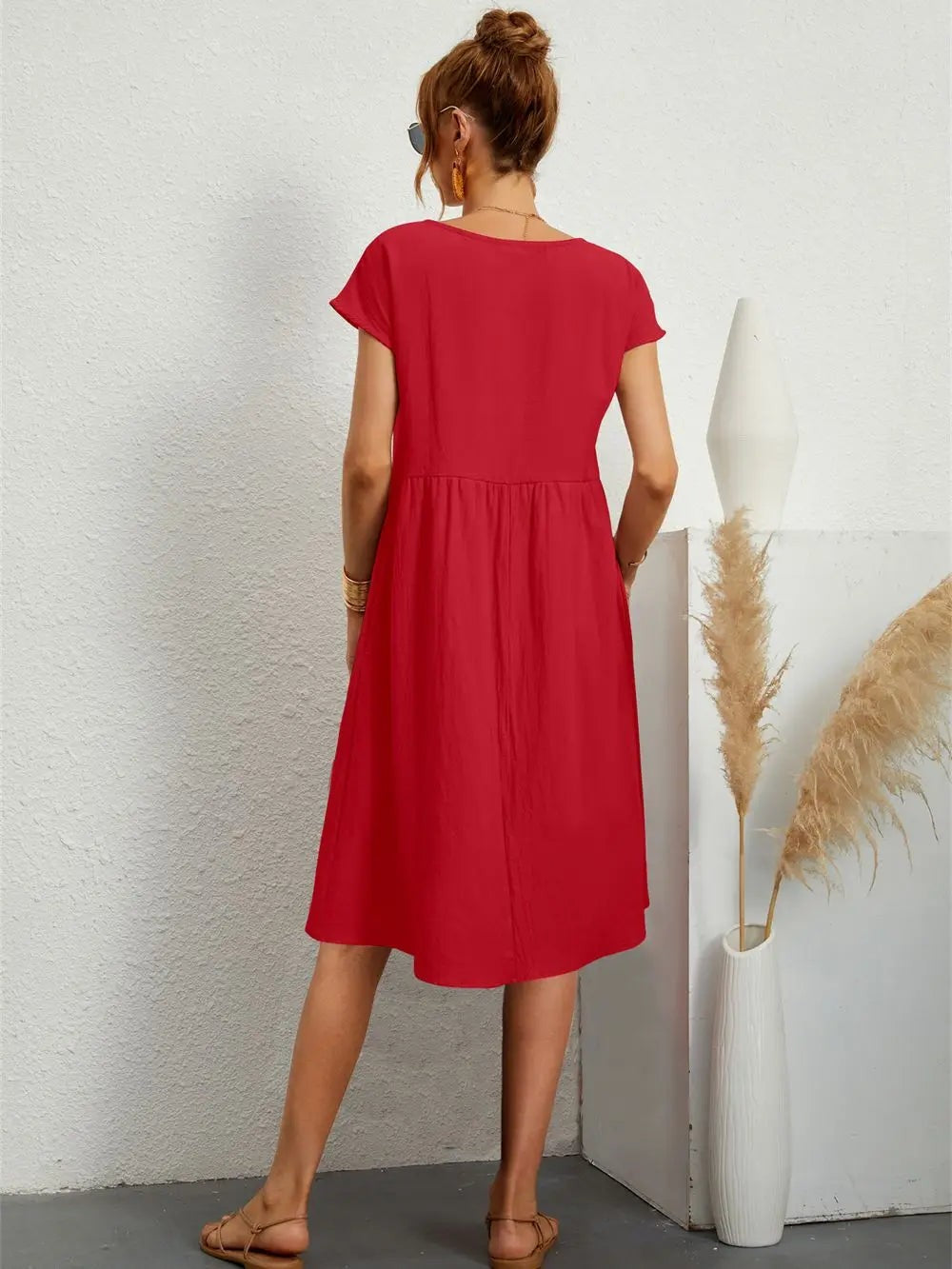 Back view of red babydoll dress showing relaxed fit and midi length