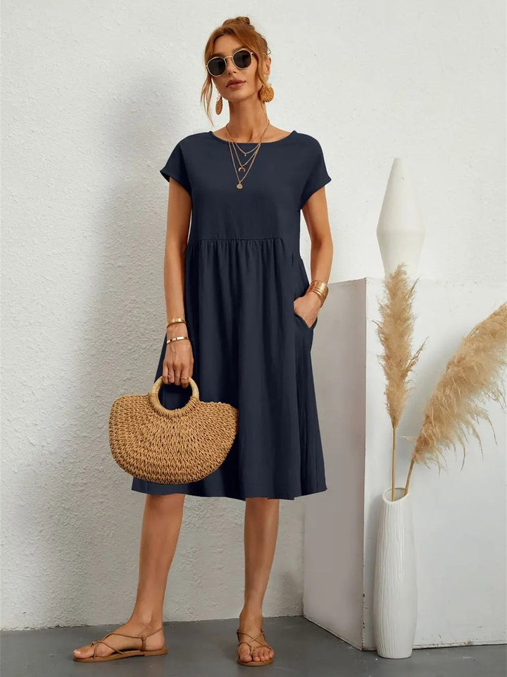Navy short-sleeve casual dress with side pockets and round neckline