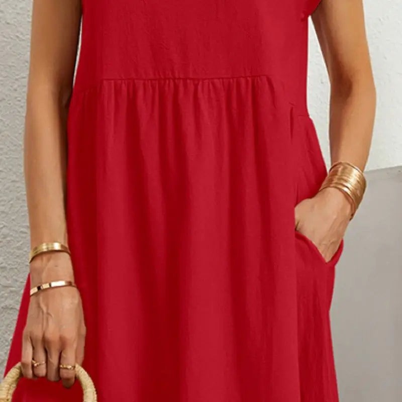 Close-up of red pocket dress fabric showing hand tucked into side pocket