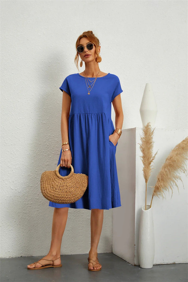 Blue short-sleeve pocket dress with flowy A-line skirt and round neck