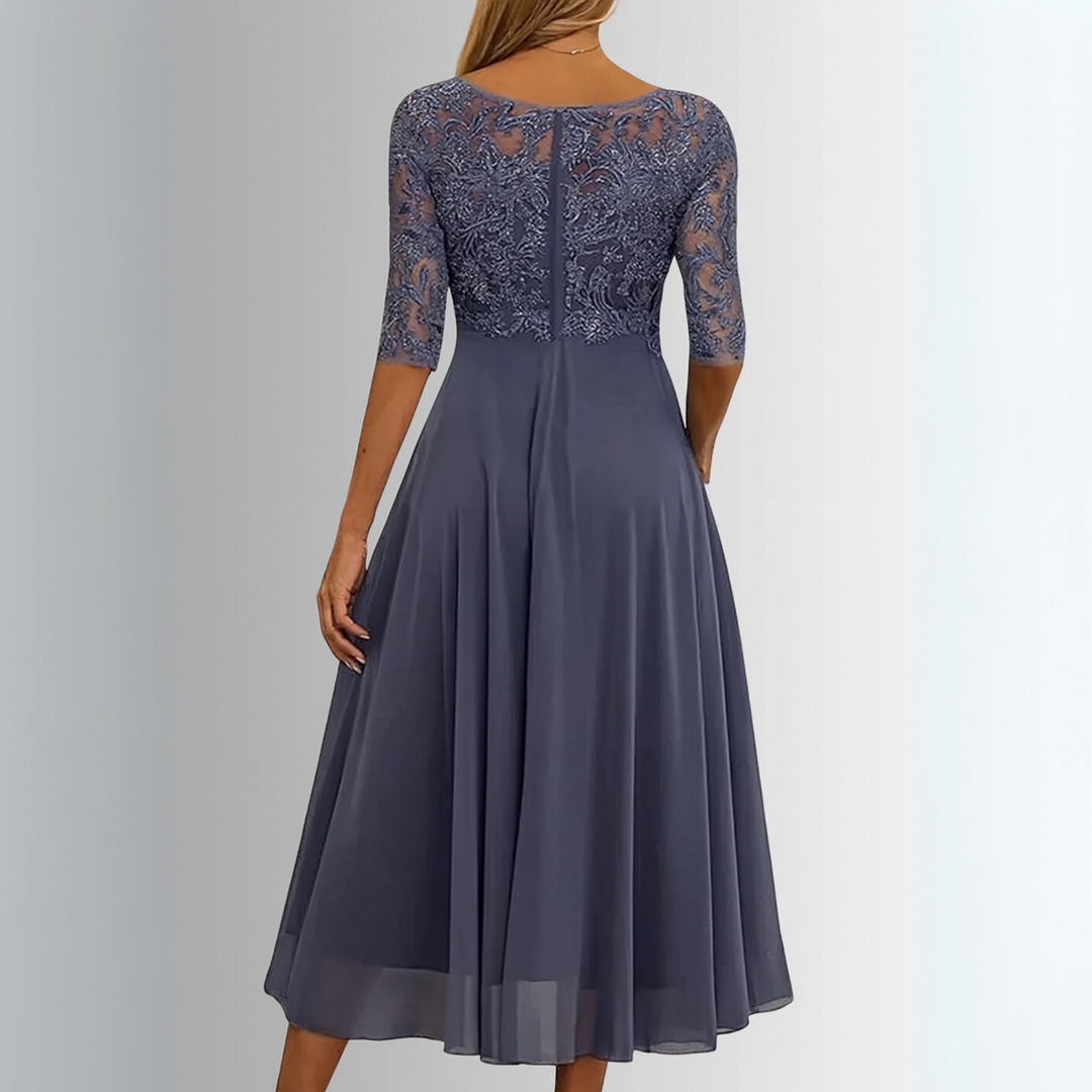Back view of blue-gray lace midi dress highlighting sheer sleeve embroidery