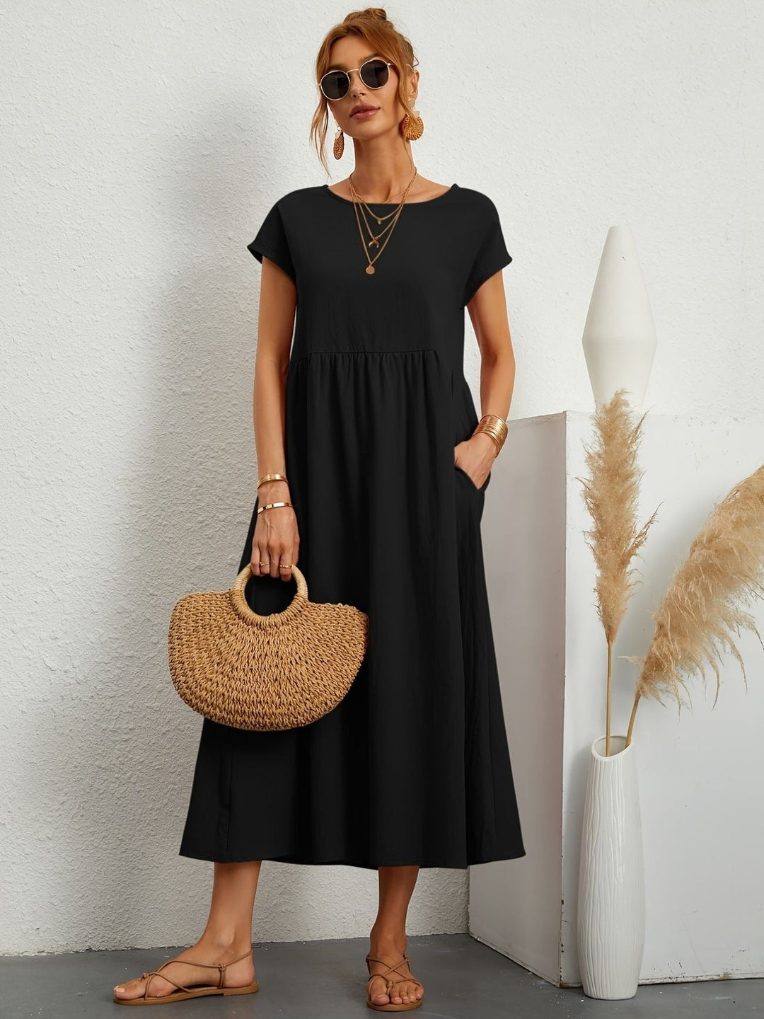Black maxi dress with cap sleeves and side pockets, relaxed fit
