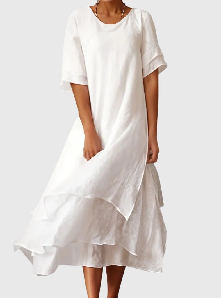 white layered maxi dress featuring flowy ruffle hem and round neckline