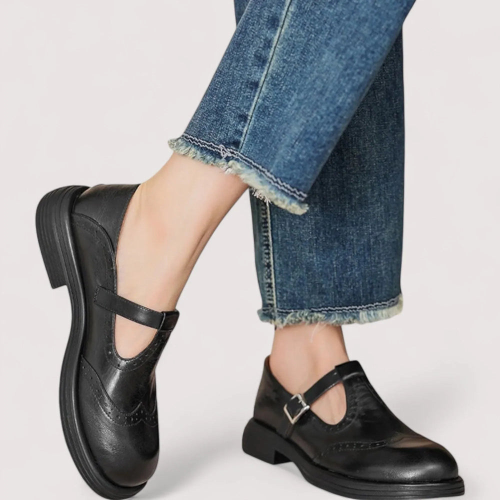 Black leather Mary Jane brogues with T-strap buckle closure, worn with cropped jeans