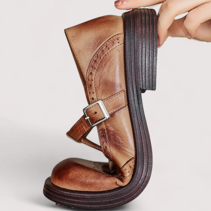 Side view of brown leather Mary Jane shoe showing stacked heel and buckle strap