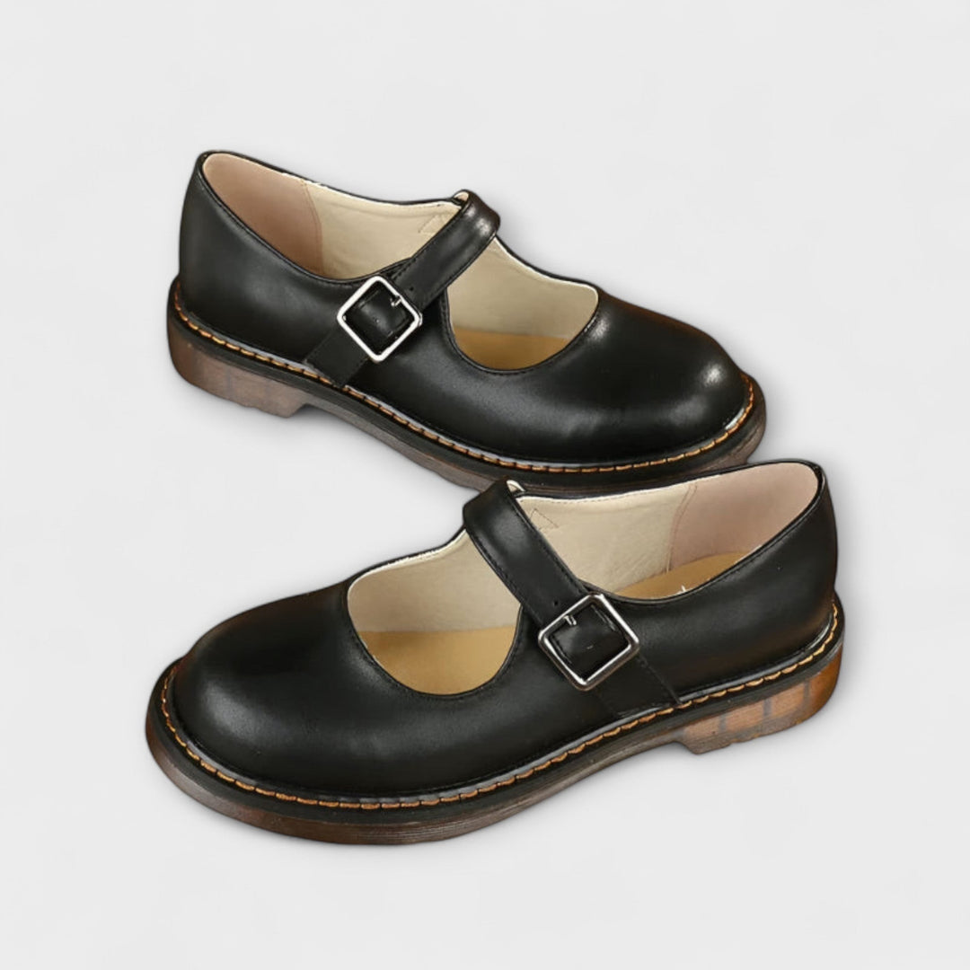 side view of black leather Mary Jane shoes with buckle closure