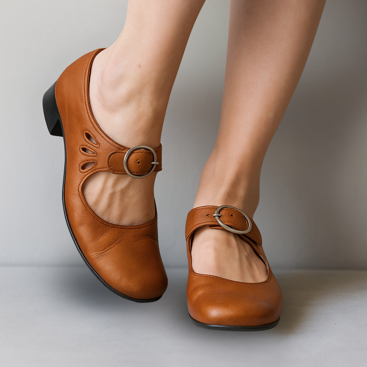 Tan leather Mary Jane flats with buckle strap and cutout accents
