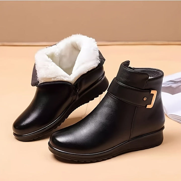 black leather ankle boots with plush faux fur lining and gold buckle strap