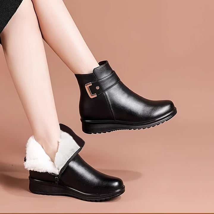 black leather ankle boots with fleece lining paired with a midi skirt