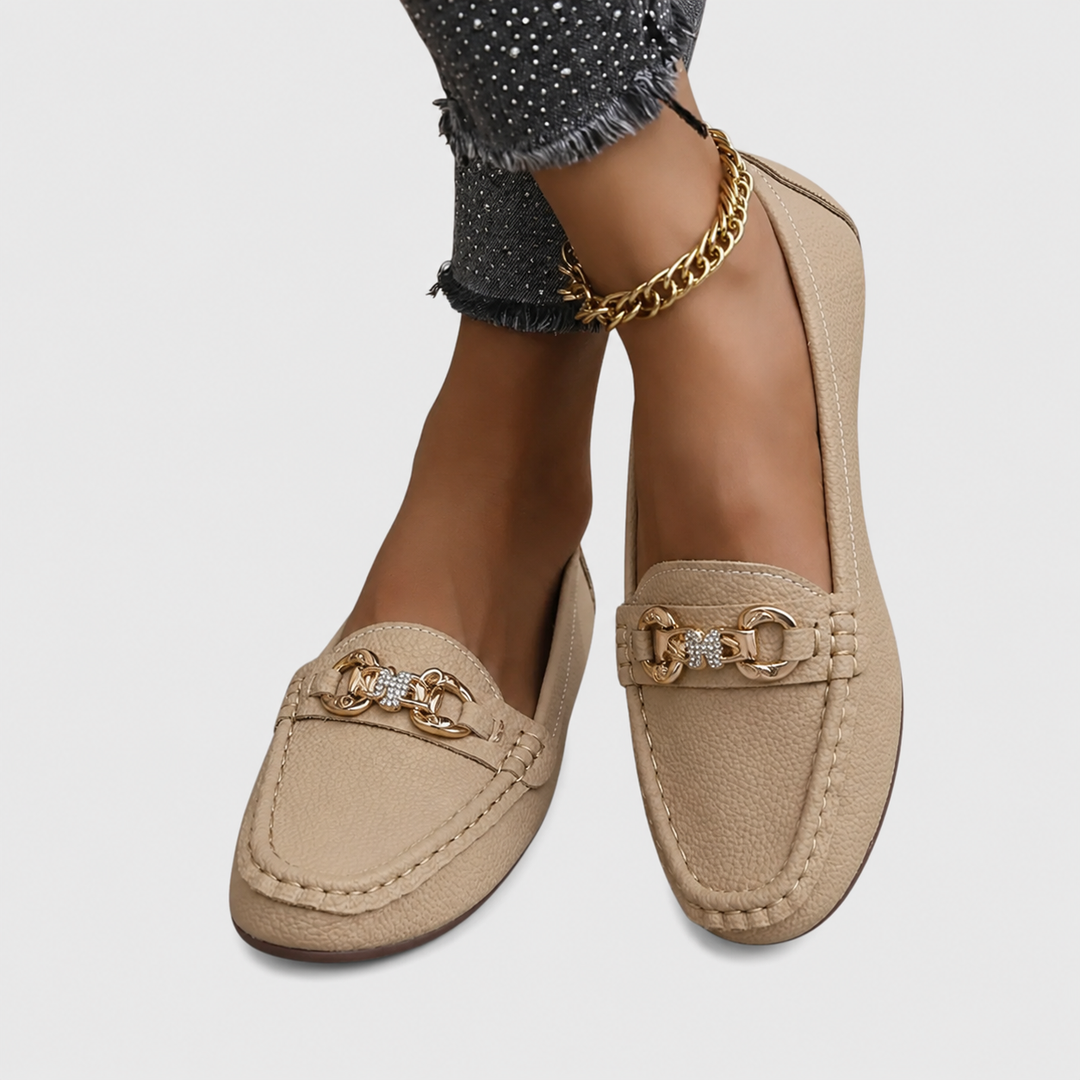 tan loafer flats with gold and rhinestone chain buckle, styled with jeans
