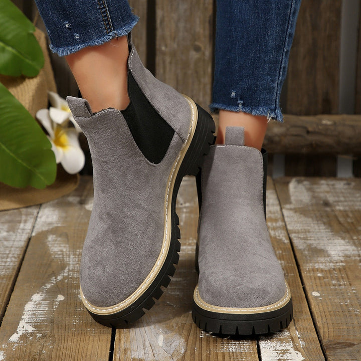 Grey suede Chelsea boots with cream stitching and thick platform sole