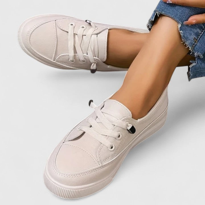 Cream leather platform sneakers with lace-up front, worn with cropped jeans