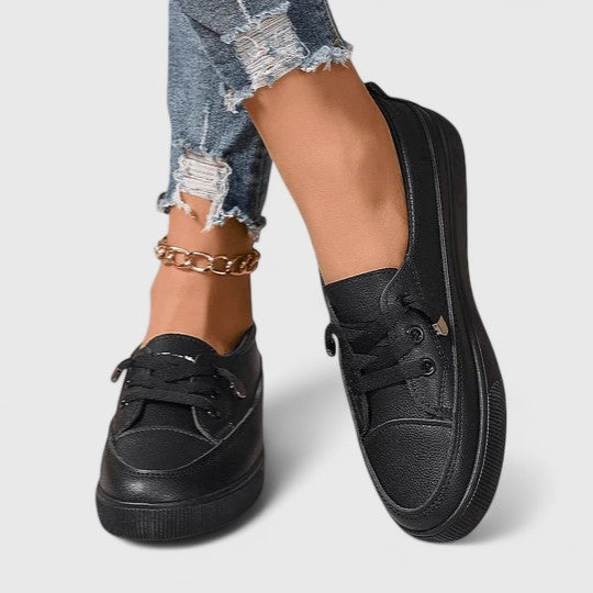 Black leather lace-up sneakers with round toe and thick platform sole