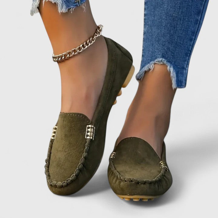 Olive green suede loafer paired with gold chain anklet and jeans