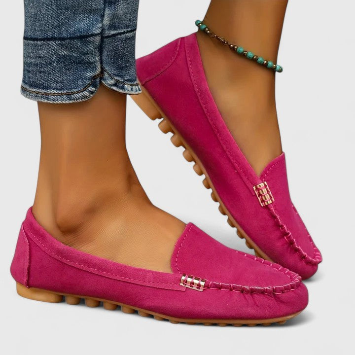 Fuchsia suede moccasin flat with textured rubber sole and stitched toe