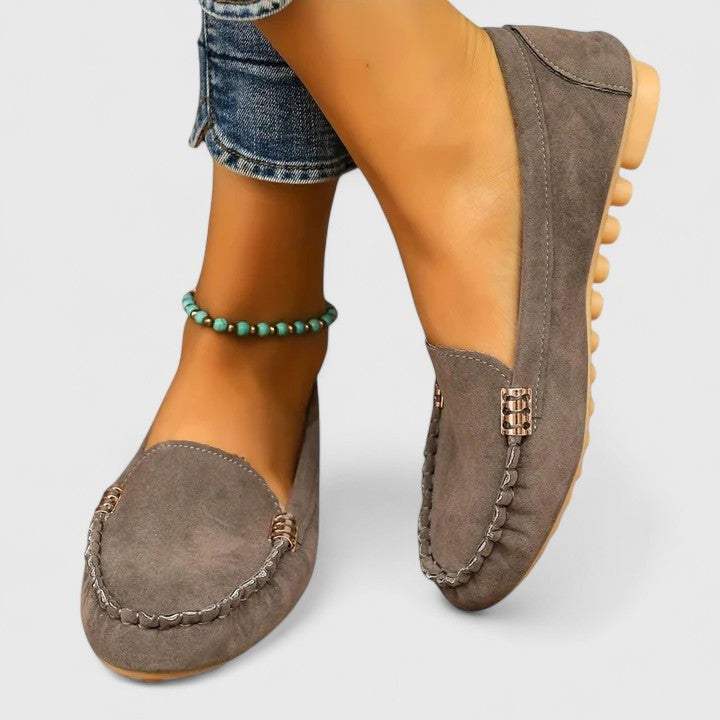 Gray suede loafer with turquoise beaded anklet and stitched apron design