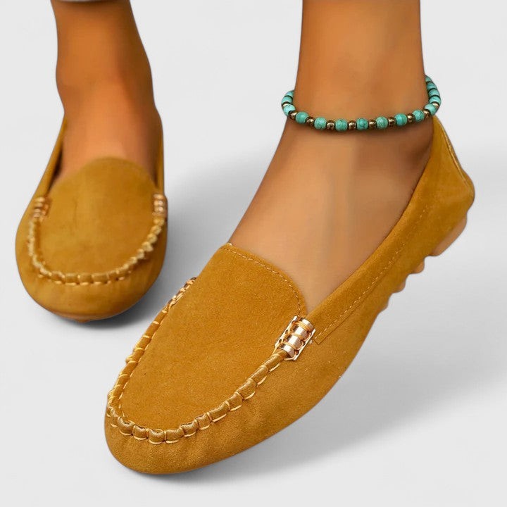 Mustard yellow suede loafer with hand-stitched detailing and gold buckle