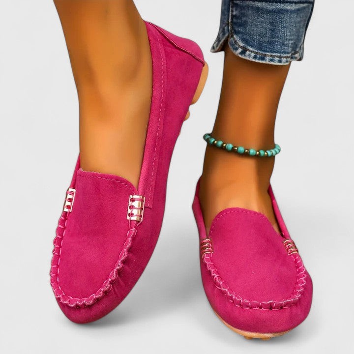 Hot pink suede loafer flat with stitched trim and gold accent detail
