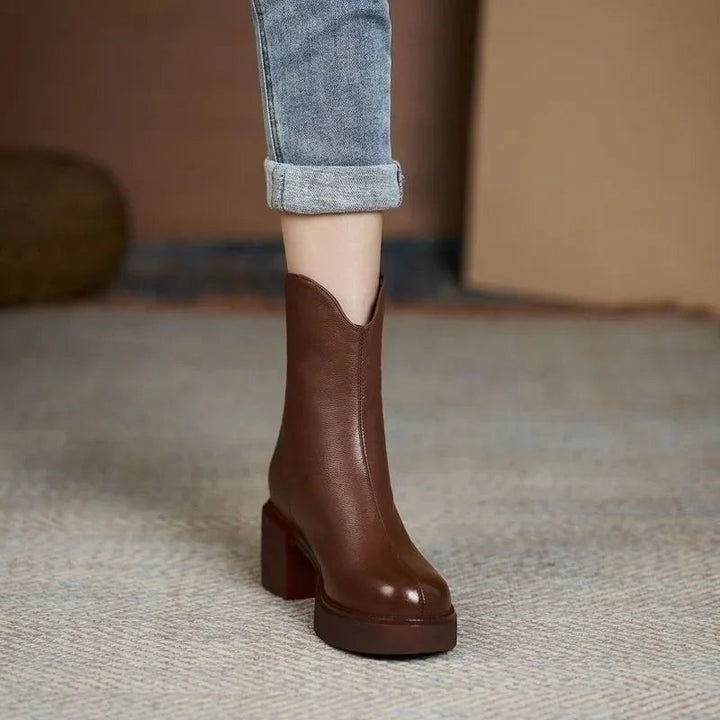 Brown leather Chelsea boots with block heel and notched ankle detail